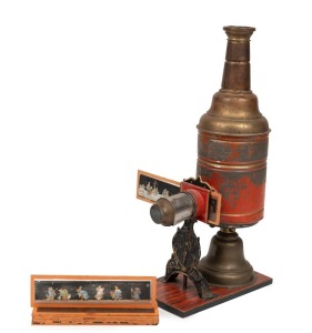 MAX DANNHORN: Children's magic lantern, height 35cm, in maker's box with ten glass slides, c. 1898.