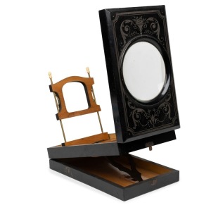 28 x 17.5 x 8cm folding graphoscope with magnifier lens, photograph holder, and carved floral decorative pattern.