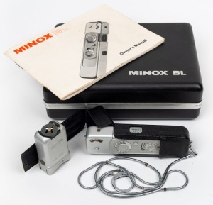 MINOX: Minox BL subminiature camera [#1201882], c. 1973, in chrome with Minox 15mm f3.5 lens. Offered in black maker's case with Minox C4 flash accessory, leatherette camera case, chain, and instruction booklet.