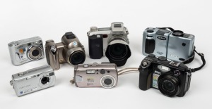 VARIOUS MANUFACTURERS: Seven digital cameras - one Nikon Coolpix 5400, one Nikon Coolpix 950 Millennium Edition with wrist strap, one Minolta DiMAGE 7i with lens hood, one Konica Minolta DiMAGE Z6, one Sony Cyber-Shot DSC-S40, one Sony Cyber-Shot DSC-S90,