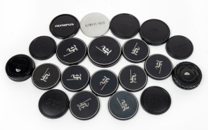 OLYMPUS: Accumulation of twenty lens caps, eleven in metal and nine in black plastic, most with Pen F logo. (20 items)