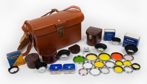 VOIGTLÄNDER: Twenty-eight camera accessories, some in maker's boxes or leather cases, comprising nineteen lens filters, five lens hoods, three leather cases, and one accessory shoe for Bessamatic or Ultramatic. (28 items)