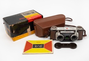 KODAK: Stereo-Kodak 35mm stereo camera, c. 1954, with twin Anaston 35mm f3.5 lenses and twin lens cap. Offered in maker's box with leather case and instruction booklet.