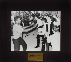 MUHAMMAD ALI, signed photograph "Muhammad Ali with The Beatles. The world's greatest sportsman and the world's greatset group meet during the Beatles first U.S. Tour in Florida", window mounted, framed & glazed, overall 82x72cm.