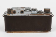 LEITZ: Chrome Model F Leica III [#139050 - corresponding to 1934], with Elmar 50mm f3.5 lens and with brown leather Leica case. Defaced Reichsadler&nbsp;symbol and anomalous 'M 66' engravings&nbsp;present above serial number on top plate likely to be fanciful addit - 4