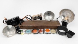 KODAK: Twenty-two accessories - one c. 1909 Brownie Developing Box, one black leather Instamatic 500 case, one self-timer in maker's box, three flash units, four lens hoods, and twelve lens filters of which six in plastic cases. (22 items)