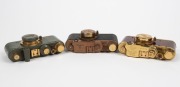 LEITZ (COUNTERFEIT): Three attractive but fanciful counterfeit 'Leicas', likely modified FED or Zorki models, each with 'Leitz Elmar' 50mm f3.5 lens and&nbsp;lens cap - one&nbsp;in gold and polished timber, one in gold and teal with fascist engraving on viewfinder, - 3