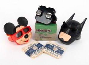 VIEW-MASTER: Three View-Master stereoscopes - one c. 1950s black Bakelite model in maker's box with twelve film reels in paper sleeves, one 1989 novelty Mickey Mouse model, and one 1995 novelty Batman model with one film reel. (3 items)