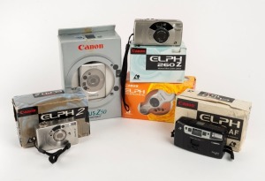 CANON: Five c. 1990s compact cameras in maker's boxes with instruction booklets - one Elph Shades Sunshine, one Elph 2, one Elph 10AF, one Elph 260Z, and one Ixus Z50 Photokit. (5 cameras)