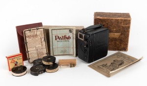 PATHÉ: Baby-Ciné Motocamera 9.5mm movie camera, c. 1920s, in maker's box with lens cap, five film rolls (including one Mickey Mouse cartoon), lighting guide, and two instruction booklets.