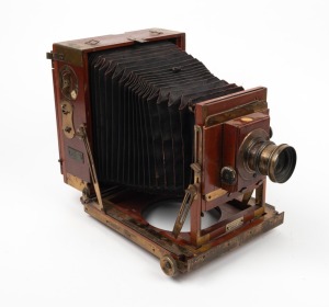 THORNTON-PICKARD: 'Unit Imperial' 4¾ x 6½" plate triple-extension field camera, c. 1904, with lens with f8/11/16/22/32/44/64 aperture markings, Thornton-Pickard roller-blind shutter, and 'Baker & Rouse' retailer's inlay.