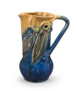 REMUED blue and yellow glazed pottery jug with applied gumnuts, leaves and branch handle, incised "Remued, Hand Made, 153M", 19.5cm high