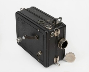 DEVRY: Circa 1926 35mm hand-cranked&nbsp;Devry&nbsp;'Lunchbox' Standard Portable Camera, with crank, internally-stored Wollensak Velostigmat&nbsp;f3.5 lens, and locking lens cap.