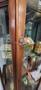 An antique English mahogany display cabinet with unusual drop-in door mechanism, metal shelf racking and chamfered sides, late 19th century, 204cm high, 89cm wide, 28cm deep - 2