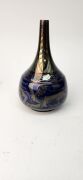 PILKINGTON ROYAL LANCASTRIAN bottle shape rich ruby & blue lustre glazed vase adorned with lions and trailing foliate motif, signed "W. S. Mycock, 1923", 23cm high - 7