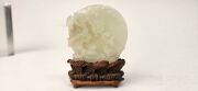 An antique Chinese jade ornament carved with blossom tree, on carved timber stand, Qing Dynasty, 18th/19th century, 8cm high overall - 4