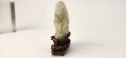 An antique Chinese jade ornament carved with blossom tree, on carved timber stand, Qing Dynasty, 18th/19th century, 8cm high overall - 6