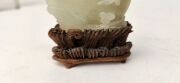 An antique Chinese jade ornament carved with blossom tree, on carved timber stand, Qing Dynasty, 18th/19th century, 8cm high overall - 14