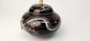 An antique Japanese cloisonne lidded pot decorated with dragon motif on black ground, with later carved ivory finial, Meiji Period, ​​​​​​​10cm high - 8
