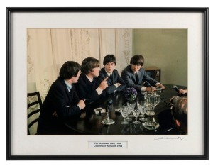 THE BEATLES IN AUSTRALIA, 1964: "The Beatles at their Press Conference Adelaide 1964", (John makes a point). Original colour print, signed by Vic Grimmett in the lower margin,  24.5 x 37cm, 35 x 46.5cm overall. 