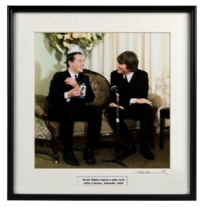 THE BEATLES IN AUSTRALIA, 1964: "Ernie Signley enjoys a joke with John Lennon, Adelaide 1964". Original colour print, signed by Vic Grimmett in the lower margin, 24.5 x 24.5cm, 35 x 34cm overall.