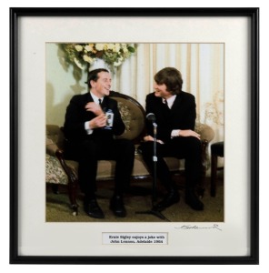 THE BEATLES IN AUSTRALIA, 1964: "Ernie Signley enjoys a joke with John Lennon, Adelaide 1964". Original colour print, signed by Vic Grimmett in the lower margin,  24.5 x 24.5cm, 35 x 34cm overall. 