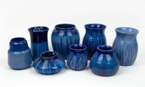 MELROSE WARE group of eight blue glazed pottery vases, the largest 17cm high