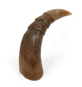 A scrimshaw cow horn decorated with an anchor and flowers, 29cm long