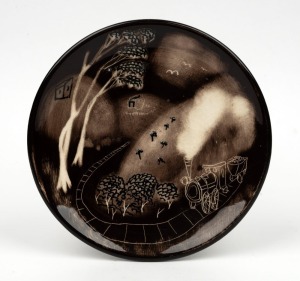 ARTHUR MERRIC BOYD unusual pottery plate with hand-painted sgraffito decoration of a locomotive and tender in bush landscape, incised "Arthur Merric Boyd", 22cm diameter