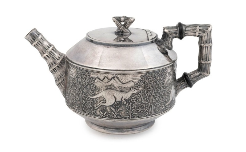 An antique Britannia metal teapot in the Chinoiserie style, adorned with rare frieze of kangaroos in landscape, 19th century, 11cm high, 18cm wide