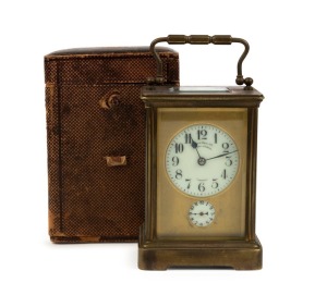 An antique French brass cased carriage clock, time and gong striking movement with alarm, original silvered lever platform escapement, retailed by Flavelle Bros. Ltd. Sydney & London, in original maroon Moroccan leather traveling case with Flavelle Brothers ribbon to the lid, circa 1880, the clock 17cm high