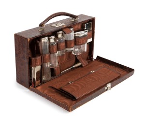 [JUDAICA] A presentation leather vanity case with silk lining and original toiletry bottles, metal pill box and paraffin burner; a pocket to the interior of the lid. A silver plaque is engraved "Presented to Mrs. S. Marks by the Perth Hebrew Ladies Benev