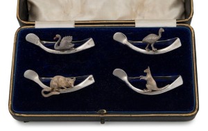 A set of four antique sterling silver wishbone napkin rings, adorned with a kangaroo, emu, possum and swan, housed in original plush fitted box, made in Birmingham, circa 1909, the box 17cm wide