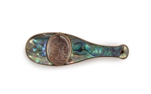 An antique New Zealand 9ct rose gold and paua shell brooch in the form of a patu, adorned with Maori cameo portrait, 19th/20th century, stamped "9ct, H.J.B.", 5.2cm wide, 7.8 grams total