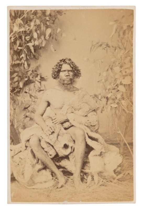 THOMAS JETSON WASHBOURNE (1832 - 1905), Portrait of Neddy Mitchell with an animal fur draped over his shoulder, albumen paper photograph laid down on carte-de-visite size card, overall 9.5 x 6.2cm.