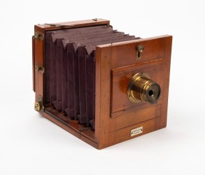 4¾ x 6½" tailboard camera with lens with four aperture settings and 'Baker & Rouse Melbourne' retailer's plate.