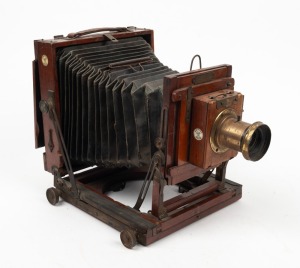 HOUGHTON: 'Ensign Victo' triple-extension field camera, c. 1900, with lens with f8/11/16/22/32/44/64 aperture markings, Ensign roller-blind shutter, and plate that reads 'Specially manufactured for Harringtons Ltd. Melbourne, Sydney, Brisbane and Adelaide