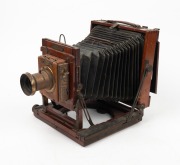 HOUGHTON: 'Ensign Victo'&nbsp;triple-extension field camera, c. 1900, with lens with f8/11/16/22/32/44/64 aperture markings,&nbsp;Ensign roller-blind shutter, and plate that reads 'Specially manufactured for Harringtons Ltd. Melbourne, Sydney, Brisbane and Adelaide - 2