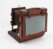 HOUGHTON: 'Ensign Victo'&nbsp;triple-extension field camera, c. 1900, with lens with f8/11/16/22/32/44/64 aperture markings,&nbsp;Ensign roller-blind shutter, and plate that reads 'Specially manufactured for Harringtons Ltd. Melbourne, Sydney, Brisbane and Adelaide - 3