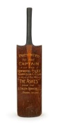 A novelty oversize presentation cricket bat, emblazoned "PRESENTED TO THE CAPTAIN OF THE IRONWORKS POLICE GARRISON CLUB IN HONOR of THEIR WINNING “THE ASHES” FROM THE LITHGOW IRONWORKS C.C. Season 1911 & 1912", 105cm high, 24cm wide