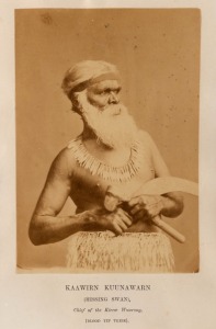 An albumen paper portrait photograph laid down on a title page from the book "Australian Aborigines" by James Dawson, 1881; the striking image depicts "KAAWIRN KUUNAWARN" (Hissing Swan), Chief of the Kirrae Wuurong people of the Mortlake District in Gippsland. The image is 15 x 10cm, laid down on the page which is mounted, framed and glazed, overall 53 x 43cm. Pen inscription verso "To Jane Leake, from Henry & Annie Leake, with love, Ap. 1881". Kawin Kuunawarn (c.1820-1889), also known as "King