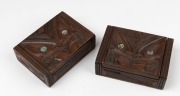 Two carved New Zealand boxes decorated with carved Tiki with paua shell eyes and with pictorial labels "Tapu: P. H. Leonard, 26 Sumner St, Rotorua, New Zealand. Guaranteed Genuine Maori Hand Carved",&nbsp; 4.5cm high, 13.5cm wide, 10cm deep