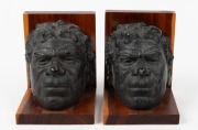 ALBERT NAMATJIRA pair of fired plaster and mulga wood bookends, mid 20th century, stamped to bases "MULGA WOOD" with Crown Mulga trademark, ​​​​​​​15cm high