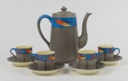 ADA NEWMAN porcelain coffee pot and four cups and saucers, hand-painted with gumnuts and gum leaves, (9 items), signed "Ada I. Newman" to bases of the cups, the coffee pot 18cm high