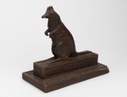 An antique carved Australian cedar kangaroo ornament with match striker base, circa 1900, 23cm high