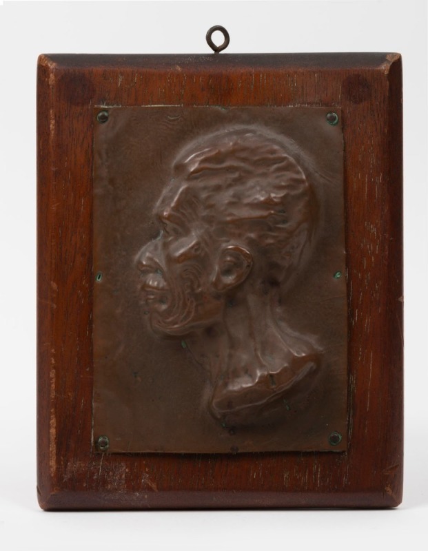 ARTIST UNKNOWN antique repousse copper plaque profile portrait of a Maori man mounted on timber board, 19th/20th century, 21 x 16.5cm overall