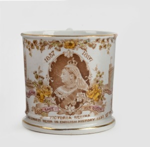 An antique English porcelain patriotic mug "Victoria Regina, The Longest Reign In English History", with portrait of Queen Victoria surrounded by vignettes including "Australasia", "India". "Cambria", "Cape Colony" and "Canada", with stamp to base "Manufa