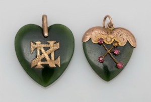 Two heart shaped New Zealand greenstone pendants mounted in 9ct gold and red stones, one with Southern Cross decoration,19th century, the larger 3.5cm high