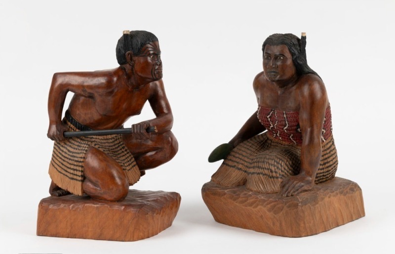 A pair of New Zealand carved and painted timber statues of kneeling Maori figures, mid 20th century, ​​​​​​​23cm high