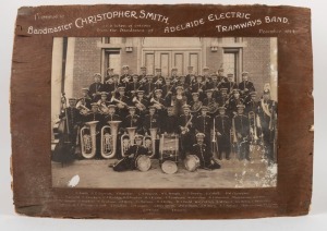 ADELAIDE ELECTRIC TRAMWAYS BAND. Large format antique black and white albumen photograph with remains of timber mount with caption "Presented To Bandmaster CHRISTOPHER SMITH, ADELAIDE ELECTRIC TRAMWAYS BAND, 1914", and further captioned with names of the 